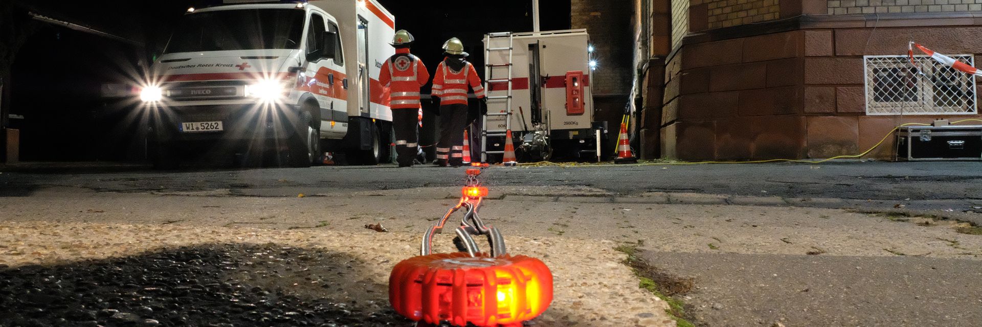 Foto: Eine DRK-Ausbilderin führt den Teilnehmern die Herzdruckmassage an einem Dummy vor.